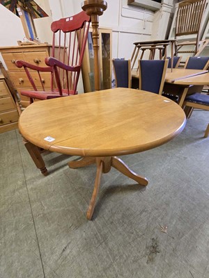 Lot 37 - A modern beech pedestal drop leaf dining table