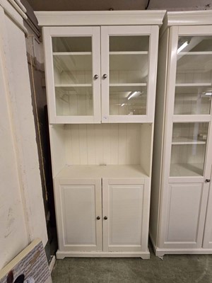 Lot 42 - A modern cream cabinet having a pair of glazed...