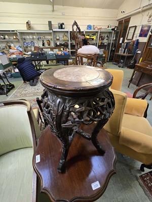 Lot 117 - A Chinese hardwood circular topped table with...