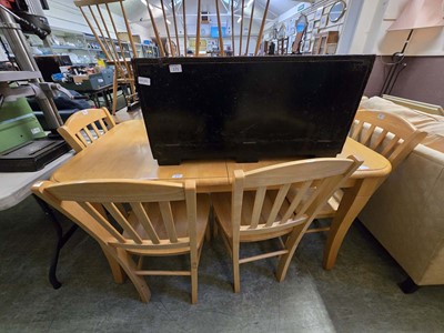 Lot 172 - A modern beech effect extending dining table...