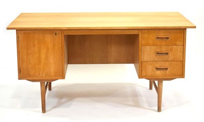 Lot 34 - A 1960's Danish oak desk, the surface...