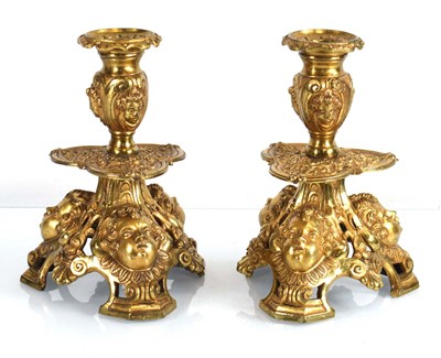 Lot 134 - A pair of gilt metal candlesticks of Rococo...