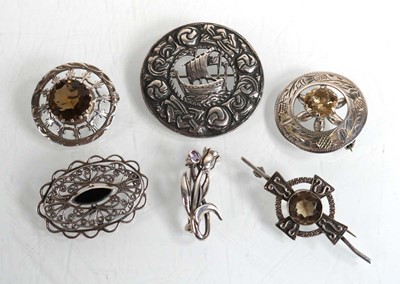 Lot 591 - Six silver and metalware brooches including...