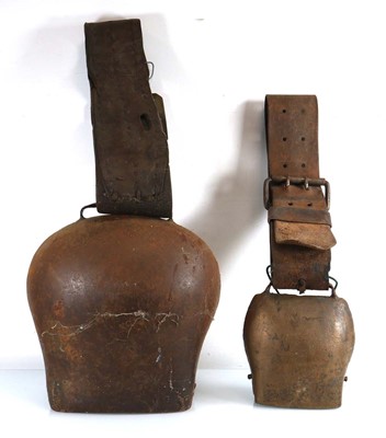 Lot 98 - Two large cowbells mounted on leather...