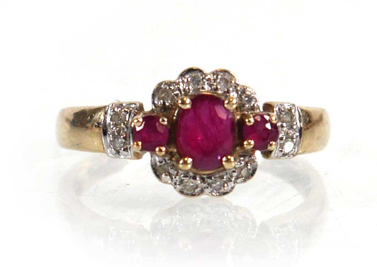 Lot 599 - A 9ct yellow gold ring set three small rubies...