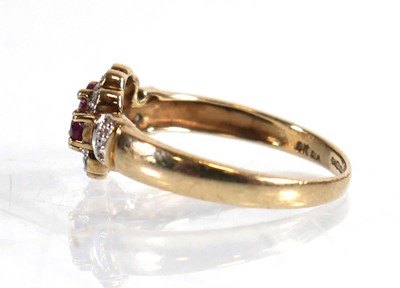 Lot 599 - A 9ct yellow gold ring set three small rubies...