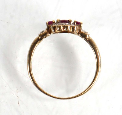 Lot 599 - A 9ct yellow gold ring set three small rubies...