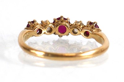 Lot 600 - An 18ct yellow gold ring set three rubies...