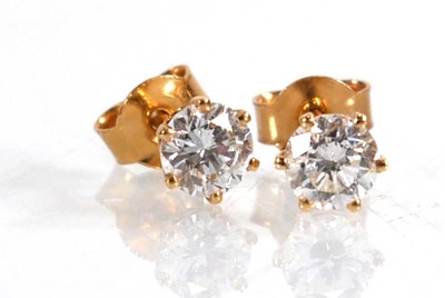 Lot 604 - A pair of 18ct yellow gold ear studs, each set...