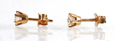 Lot 604 - A pair of 18ct yellow gold ear studs, each set...