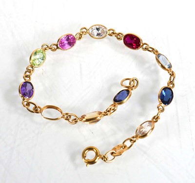 Lot 605 - An 18ct yellow gold bracelet set semi precious...