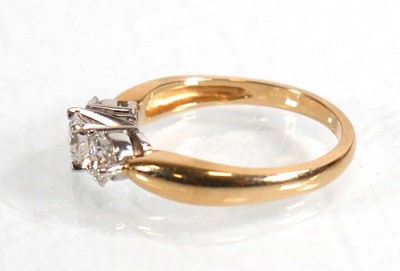 Lot 608 - A 14ct yellow gold ring set three brilliant...