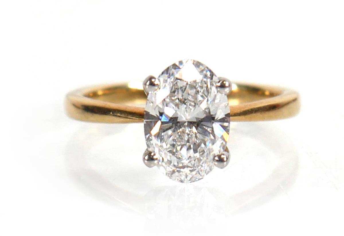 Lot 609 - A yellow metal ring set oval lab grown diamond...