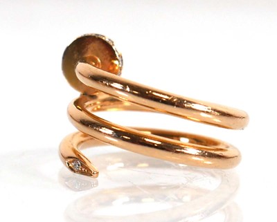 Lot 610 - A yellow metal serpent design ring set...