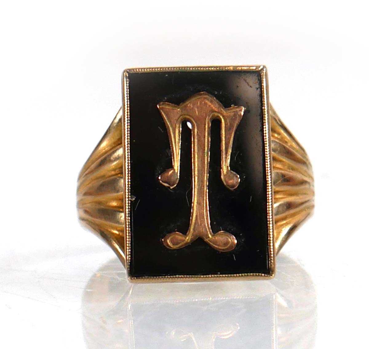 Lot 615 - A 9ct yellow gold signet ring set black...