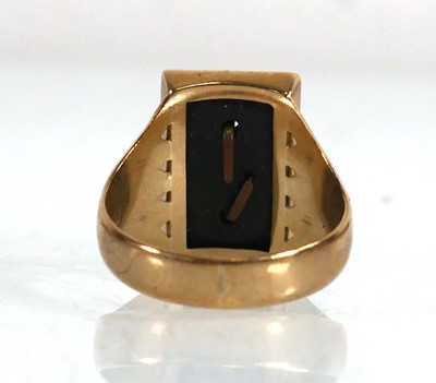 Lot 615 - A 9ct yellow gold signet ring set black...