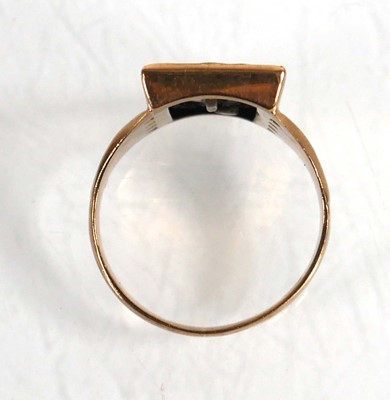 Lot 615 - A 9ct yellow gold signet ring set black...