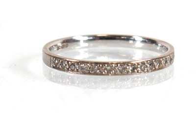 Lot 619 - An 18ct white gold half eternity ring set...