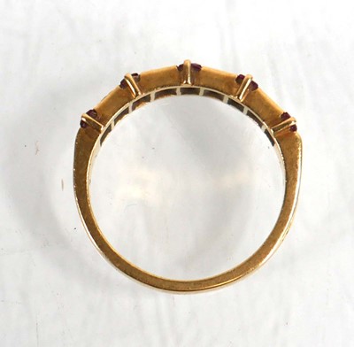 Lot 646 - An 18ct yellow gold half eternity ring set...