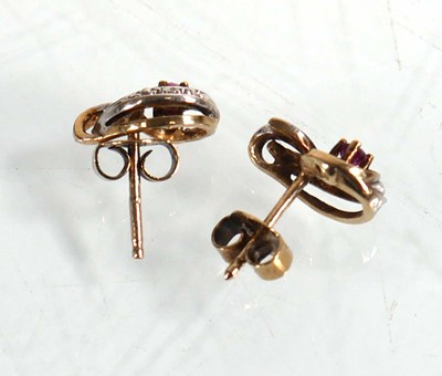 Lot 652 - A pair of 9ct yellow gold ear studs, each set...