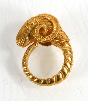 Lot A yellow metal ring in the form of a rams head...