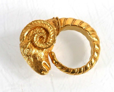 Lot A yellow metal ring in the form of a rams head...