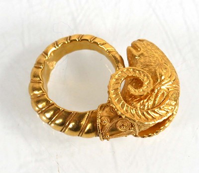 Lot A yellow metal ring in the form of a rams head...