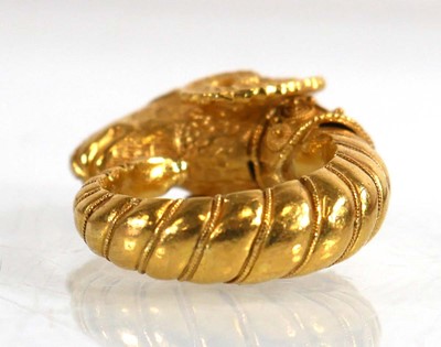 Lot A yellow metal ring in the form of a rams head...