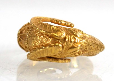 Lot A yellow metal ring in the form of a rams head...