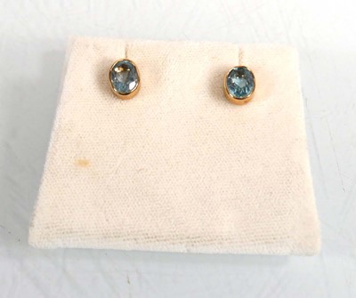 Lot 624 - A pair of 9ct yellow gold ear studs, each set...