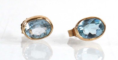 Lot 624 - A pair of 9ct yellow gold ear studs, each set...