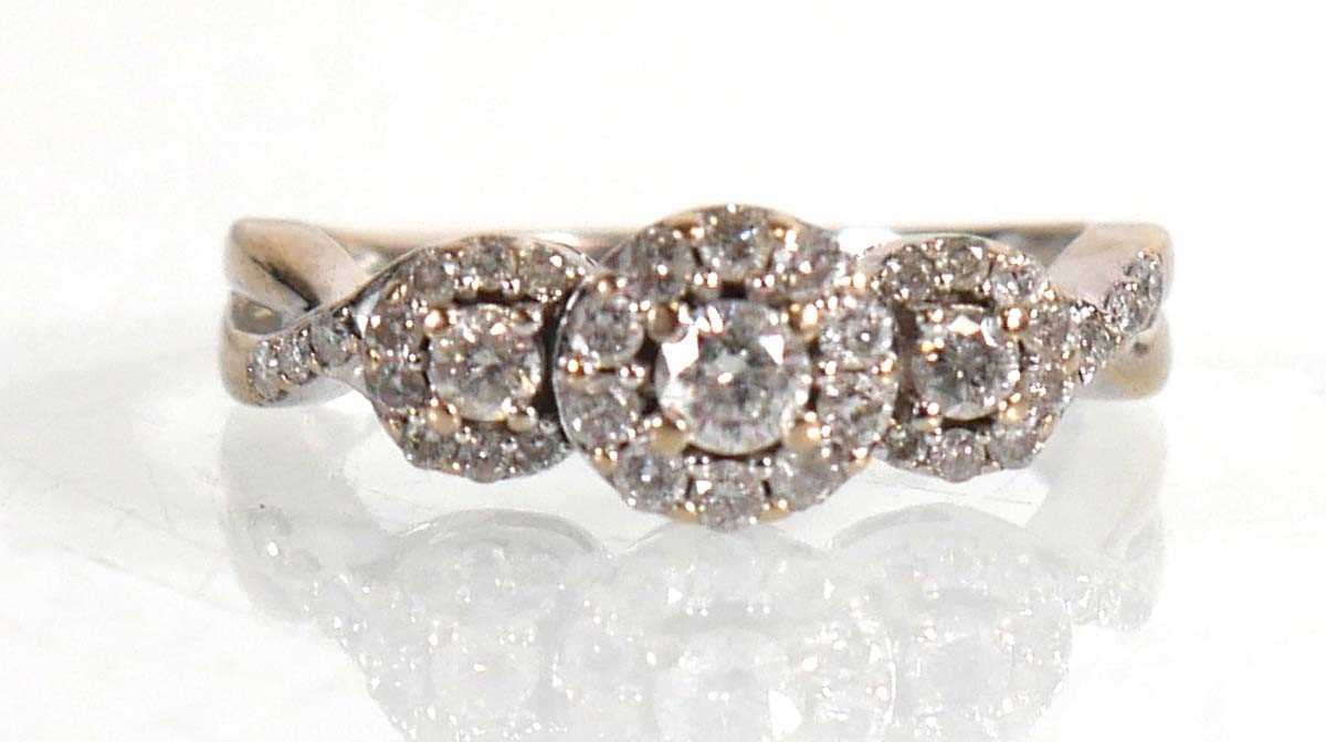 Lot 672 - An 18ct white gold ring set three diamonds...