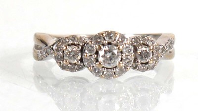 Lot 672 - An 18ct white gold ring set three diamonds...