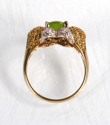 Lot 675 - A 14ct yellow gold ring set oval green stone...