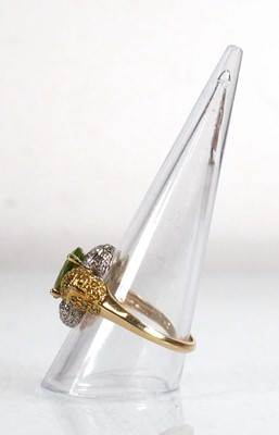 Lot 675 - A 14ct yellow gold ring set oval green stone...