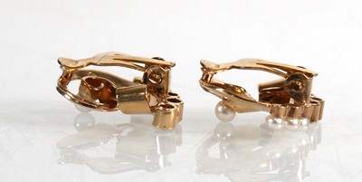 Lot 680 - A pair of 9ct yellow gold ear clips, each set...