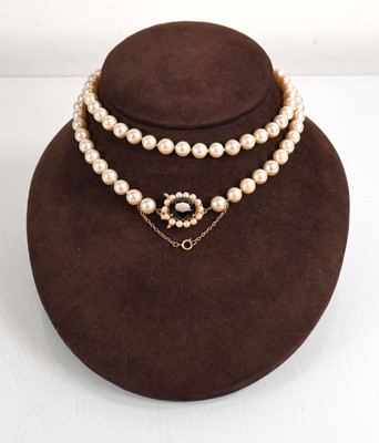 Lot 687 - A single strand cultured pearl necklace with a...