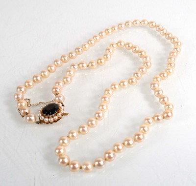 Lot 687 - A single strand cultured pearl necklace with a...