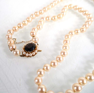 Lot 687 - A single strand cultured pearl necklace with a...