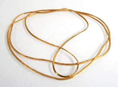 Lot 690 - An 18ct yellow gold triple strand textured...