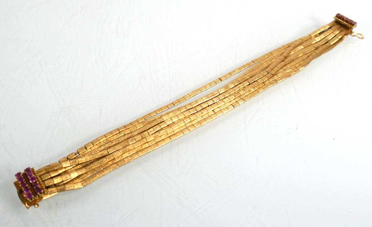 Lot 691 - An 18ct yellow gold nine strand textured...