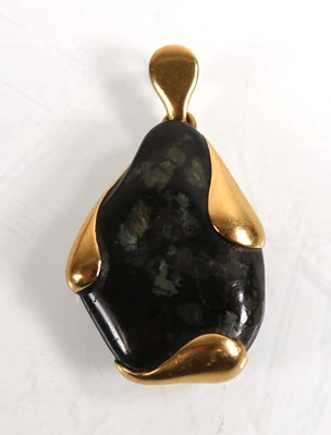 Lot 695 - A yellow metal pendant inset black...