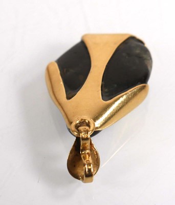 Lot 695 - A yellow metal pendant inset black...