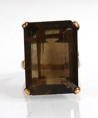 Lot 701 - A 9ct yellow gold ring set smoky quartz in a...