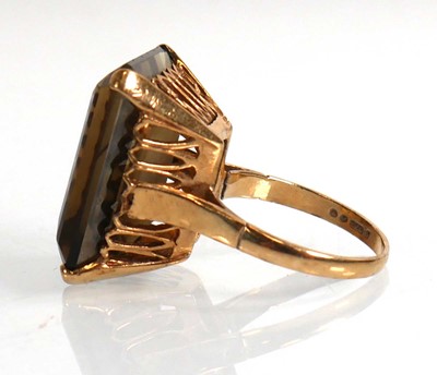 Lot 701 - A 9ct yellow gold ring set smoky quartz in a...