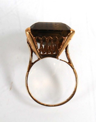 Lot 701 - A 9ct yellow gold ring set smoky quartz in a...