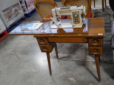 Lot 1274 - Dark oak sewing machine table with integral...