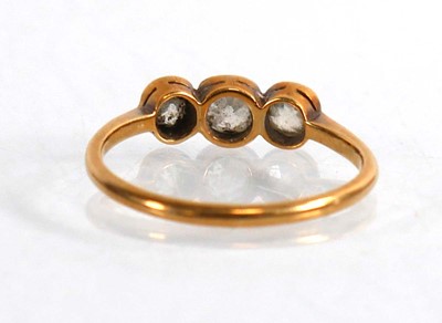 Lot 704 - An 18ct yellow gold ring set three graduated...