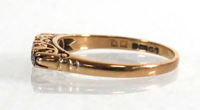 Lot 711 - A 9ct yellow gold ring set three graduated...