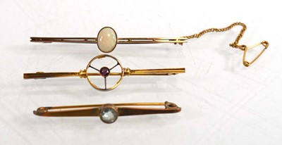 Lot 714 - A yellow metal bar brooch set oval opal within...